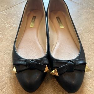 Louise et Cie black leather flats with gold studs on bow of toe size 8M.